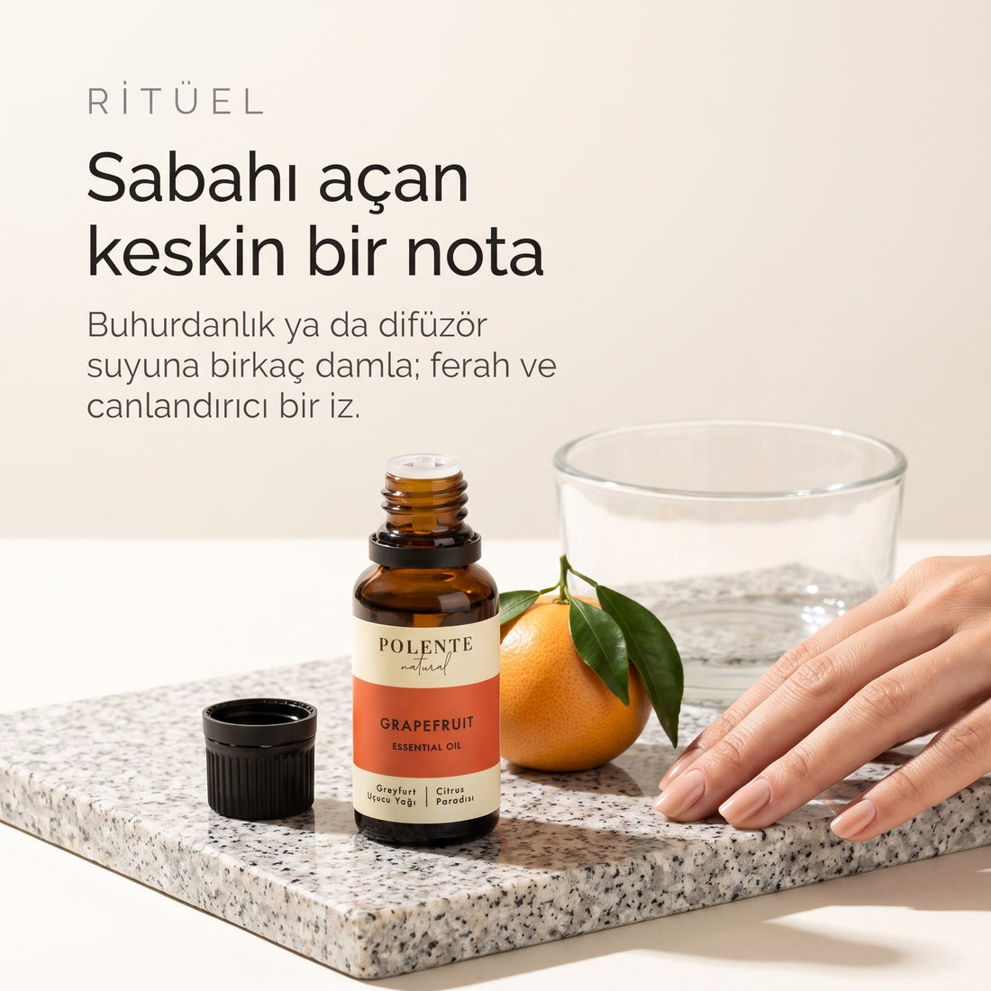 Greyfurt Uçucu Yağı 10 ml — buhurdanlık ritüeli, granit yüzeyde açık şişe ve greyfurt