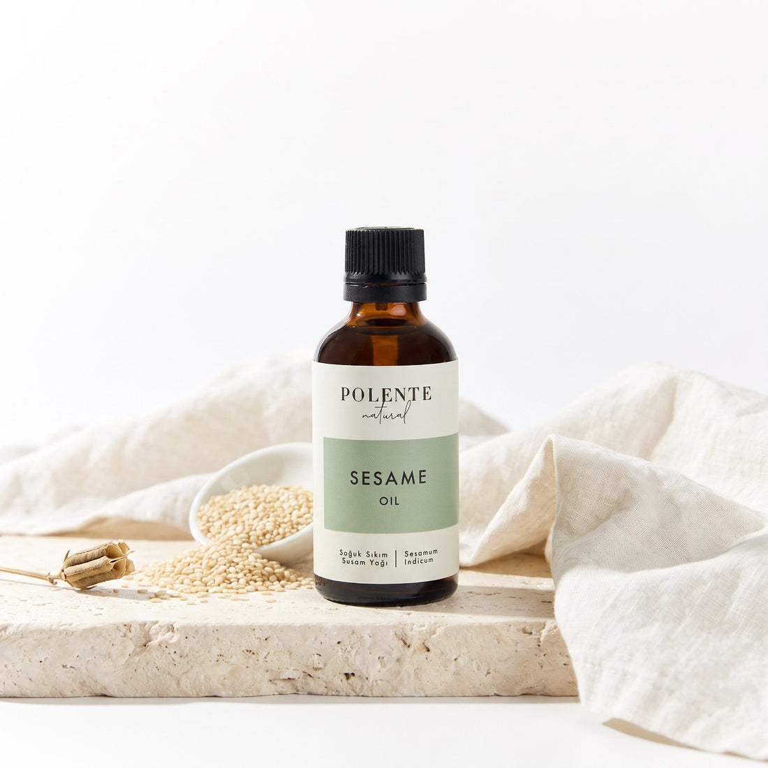 Susam Yağı Soğuk Sıkım 50 ml — susam tohumları ve kapsülüyle botanik konsept görseli