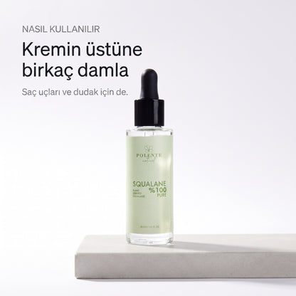%100 Pure Squalane 30 ml — kremin üstüne birkaç damla, taş kaide üzerinde